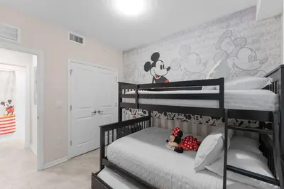a bedroom with two bunk beds with a mickey mouse mural at 3120-102 Resort Pool View Disney Universal Orlando in Kissimmee
