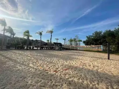 a train on the tracks on a beach with palm trees at Casa Bella Vida Resort Kissimmee in Kissimmee