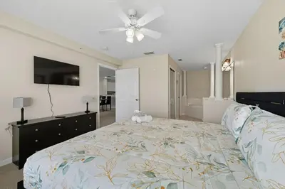 a bedroom with a bed and a ceiling fan at Spacious 2BR Condo Near Disney with Pool & Basketball in Kissimmee