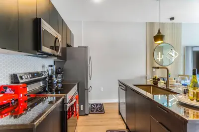 a kitchen with a stainless steel refrigerator and a sink at 3 Bedroom 8 Miles from Disney Word in Kissimmee
