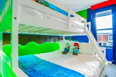 a bedroom with a bunk bed with two stuffed toys at 3 Bedroom 8 Miles from Disney Word in Kissimmee