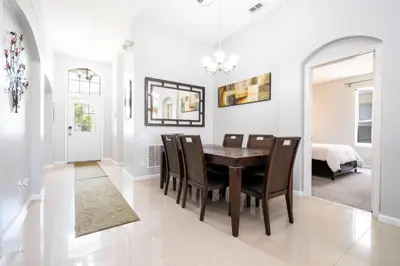 a dining room with a table and chairs at Game Room 4 BD Private Pool BBQ 2252 in Kissimmee