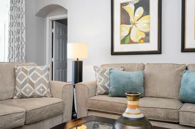 a living room with two couches and a table at Game Room 4 BD Private Pool BBQ 2252 in Kissimmee