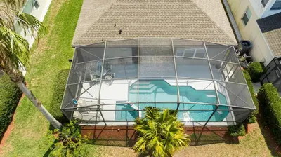 an image of a glass house with a swimming pool at Game Room 4 BD Private Pool BBQ 2252 in Kissimmee