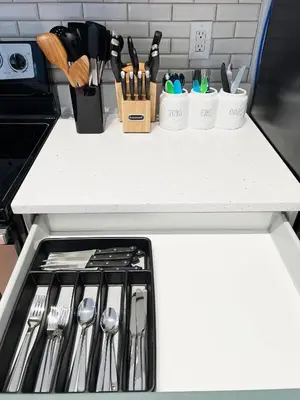 a kitchen counter with a bunch of utensils at [Popular Illusion Home] •Waterfront Private Pool in Kissimmee