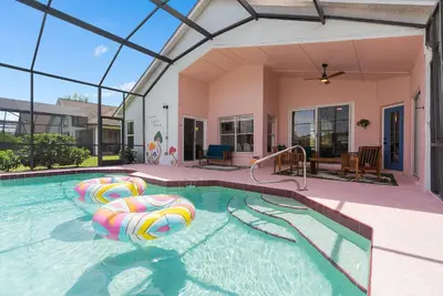 a swimming pool with inflatables in a house at [Popular Illusion Home] •Waterfront Private Pool in Kissimmee