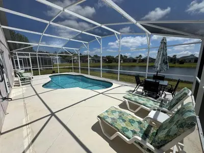 a patio with two chairs and a swimming pool at Ortega Villa home in Kissimmee