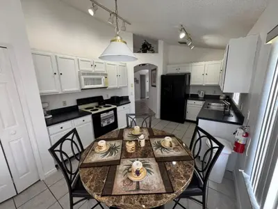 a kitchen with a table and chairs in a room at Ortega Villa home in Kissimmee