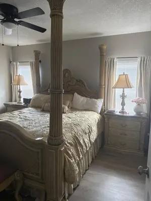 a bedroom with a large bed with a column at Cozy family house near Disney,epic and universal in Orlando