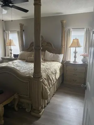 a bedroom with a large bed and two night stands at Cozy family house near Disney,epic and universal in Orlando