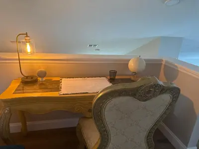 a desk with a lamp and a chair in a room at Cozy family house near Disney,epic and universal in Orlando