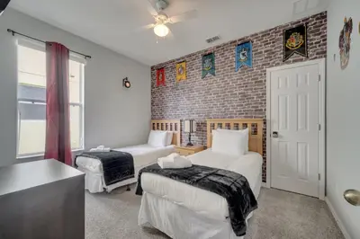 a bedroom with two beds and a brick wall at Disney Getaway Pool Gated Resort Near Parks in Kissimmee