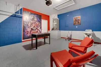 a room with a table and chairs and a painting at Disney Getaway Pool Gated Resort Near Parks in Kissimmee