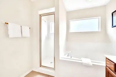 a bathroom with a mirror and a sink at Bella Vida House with Pool and Games - Near Disney! in Kissimmee