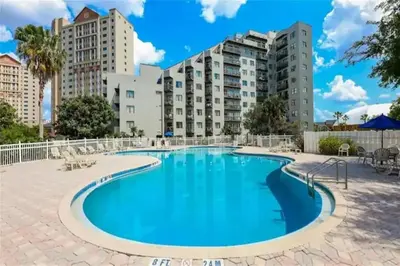 a large swimming pool with buildings in the background at Apartamento Moderno 2 Quartos The Enclave in Orlando