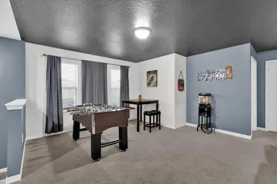 a room with a ping pong table and a game room at Neverland Nook in Orlando