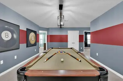 a billiard room with a pool table and bats at Neverland Nook in Orlando