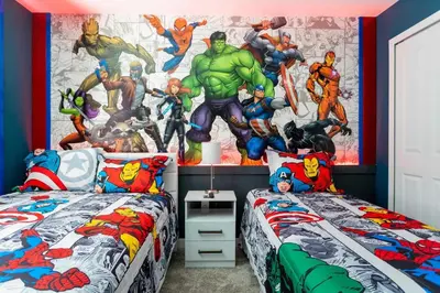 a bedroom with two beds with superheroes mural on the wall at Townhouse Moderna 4Q c/ Piscina /10 Min da Disney! in Kissimmee