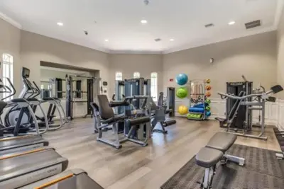 a gym with treadmills and machines in a room at Moderno 3 Quartos no Vista Cay Resort in Orlando