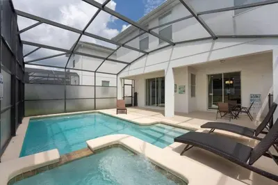 an indoor swimming pool with a glass ceiling at Vila 6 Quartos Storey Lake com Piscina & Spa in Kissimmee