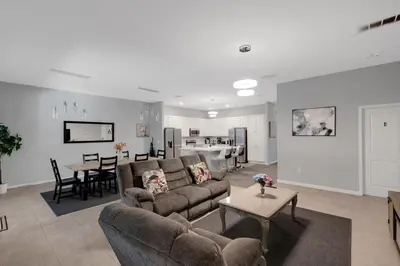 a living room with a couch and a table at Cozy Rooms In An Elegant House in Kissimmee