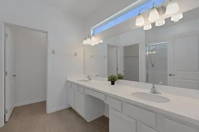 a white bathroom with two sinks and a mirror at Cozy Rooms In An Elegant House in Kissimmee