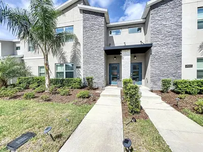a house with a sidewalk in front of a building at Luxury Pool Home Near Disney Resort Access in Kissimmee