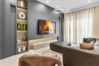 a living room with a couch and a fireplace at 2026 Luxury 5Bedrooms At Paradiso Grande in Orlando