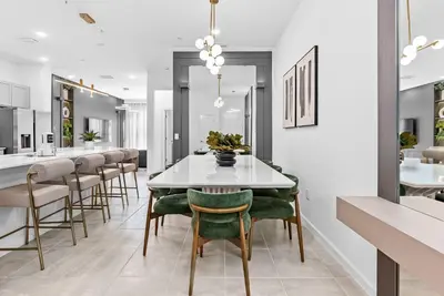 a dining room with a white table and chairs at 2026 Luxury 5Bedrooms At Paradiso Grande in Orlando