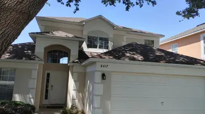 a house with a white garage at Magnificent View-Close to Disney in Kissimmee