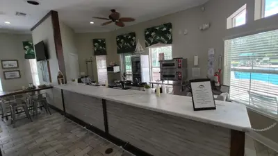 a large kitchen with a bar with a table at Magnificent View-Close to Disney in Kissimmee