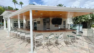 a bar with chairs under a pavilion at Magnificent View-Close to Disney in Kissimmee