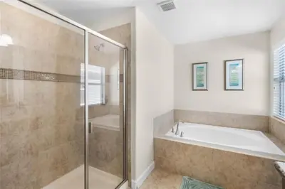 a bathroom with a shower and a bath tub at Luxury Pool Home Near Disney Resort Amenities in Kissimmee