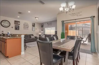 a dining room and living room with a table and chairs at Disney & Resort Fun Private Pool Renovated in Kissimmee