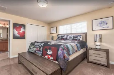 a bedroom with a large bed and a night stand at Disney & Resort Fun Private Pool Renovated in Kissimmee