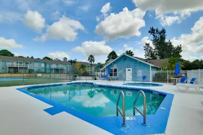 a swimming pool in a yard with a house at 5 Mi to WDW Resort-Style Condo with Pool Access in Kissimmee