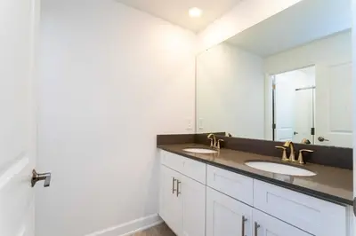 a bathroom with two sinks and a large mirror at Stylish & Fun Retreat Pool Themed Rooms in Kissimmee