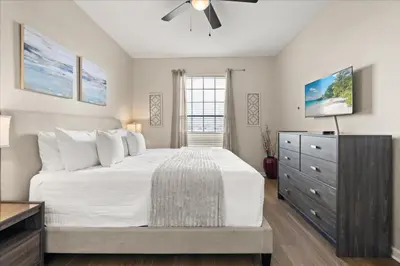 a bedroom with a large bed and a dresser at 3 Bedrooms 2 Bathrooms Vista Cay 4814-405 Ca in Orlando