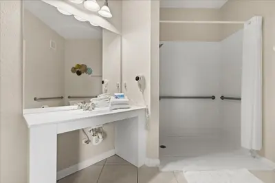a white bathroom with a sink and a shower at 3 Bedrooms 2 Bathrooms Vista Cay 4814-405 Ca in Orlando