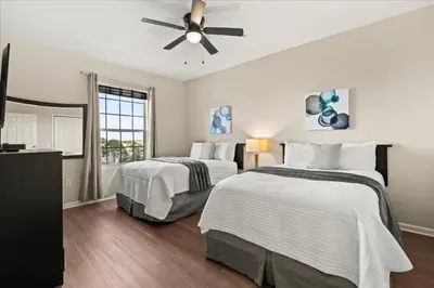 a bedroom with two beds and a ceiling fan at 3 Bedrooms 2 Bathrooms Vista Cay 4814-405 Ca in Orlando