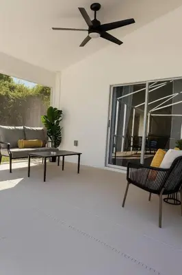 a living room with a ceiling fan and a couch at Once upon a good stay - 7 Beds Pool Home by Disney in Kissimmee