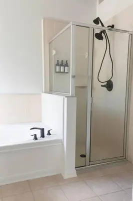 a bathroom with a shower and a sink at Once upon a good stay - 7 Beds Pool Home by Disney in Kissimmee