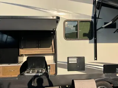 an rv with its door open with a chair in it at Beautiful RV 15 Min to Downtown Orlando in Orlando