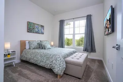 a bedroom with a bed and a window at New Vacay Home 5BD 5BA - 5 miles to Disney in Orlando