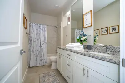 a white bathroom with a sink and a shower at New Vacay Home 5BD 5BA - 5 miles to Disney in Orlando