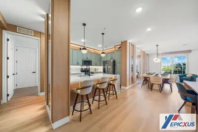 an open kitchen and dining room with a bar and chairs at The Epic New Jersey Vista Cay in Orlando