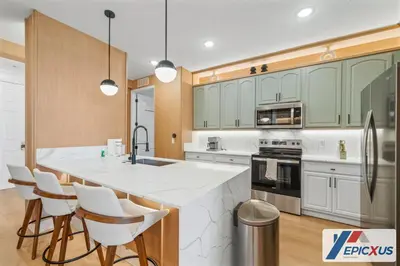 a kitchen with a large island with white counter tops at The Epic New Jersey Vista Cay in Orlando