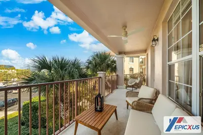 a balcony with a couch and a table at The Epic New Jersey Vista Cay in Orlando