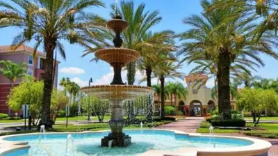 a fountain in a park with palm trees at Moderno apê 3 quartos no Vista Cay – Perto Disney in Orlando