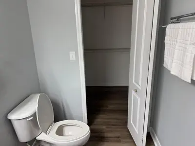 a bathroom with a white toilet in a room at Bellavue Getaway in Kissimmee
